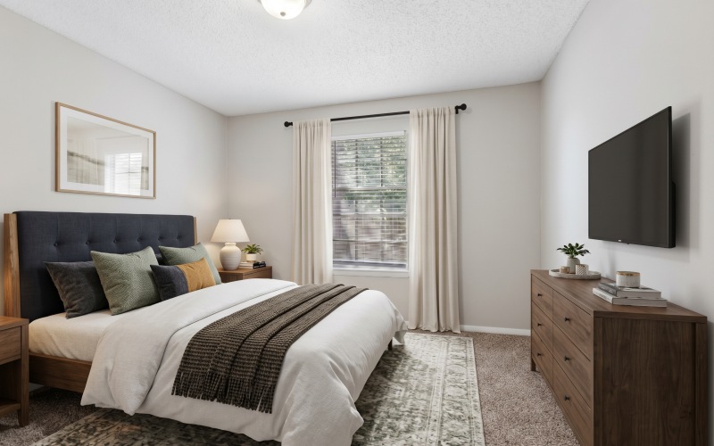 bedroom with bed, dresser, and TV