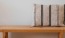 a wooden bench with a striped pillow on it
