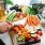 person cutting a kitchen counter full of vegetables