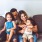 young family of four sit on couch