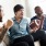 men sitting on couch get excited about football