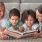 grandparents read to their grandchildren on living room floor