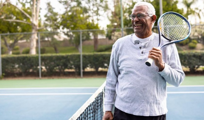 a man holding a tennis racket and tennis ball